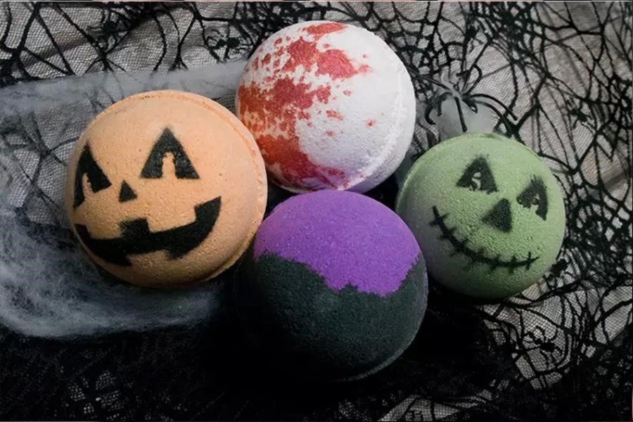 Four styles of Halloween themed bath bombs on spooky table