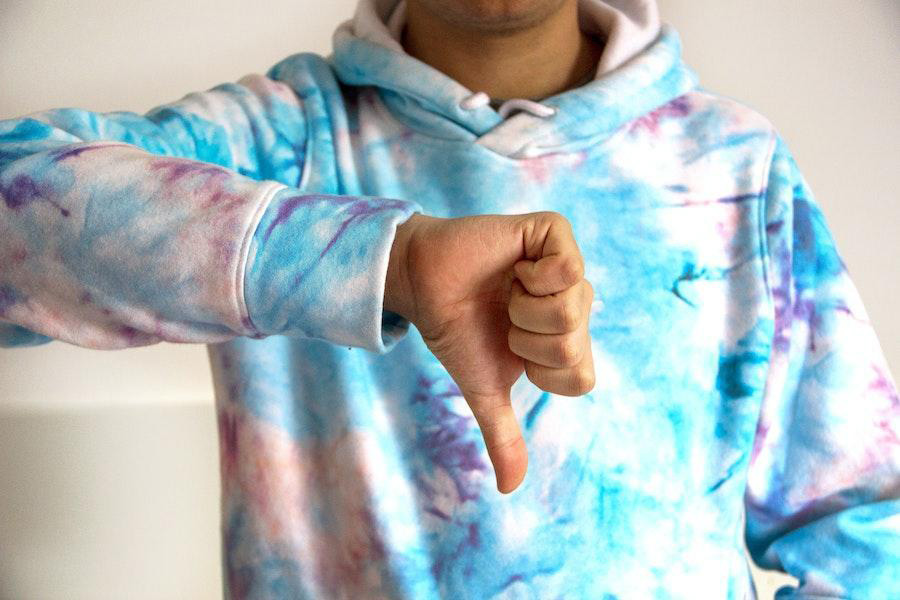 Man giving a thumbs down in psychedelic knit