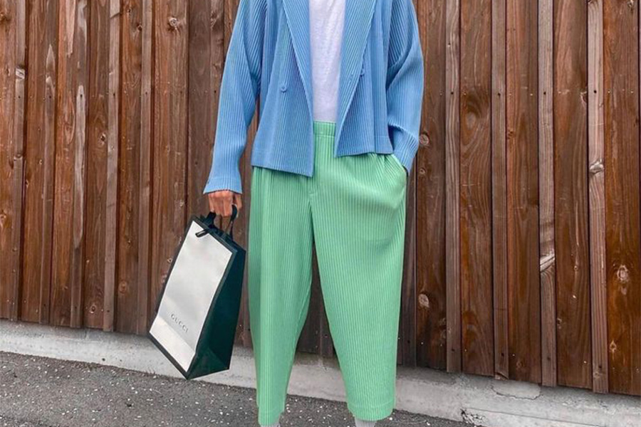 man holding a bag with green parachute pants