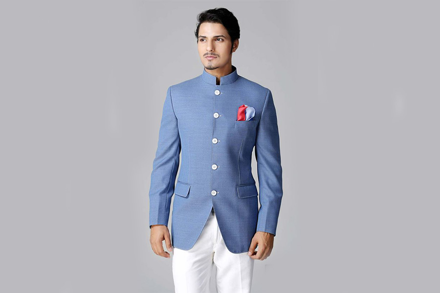 Man posing in a blue Nehru-collar jacket