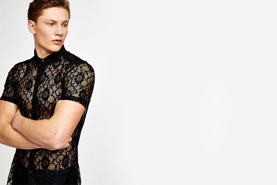 Man posing with open lace shirt