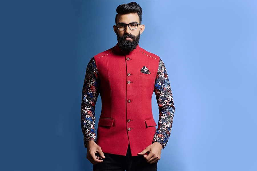 Man standing in a red patterned Nehru-collar jacket