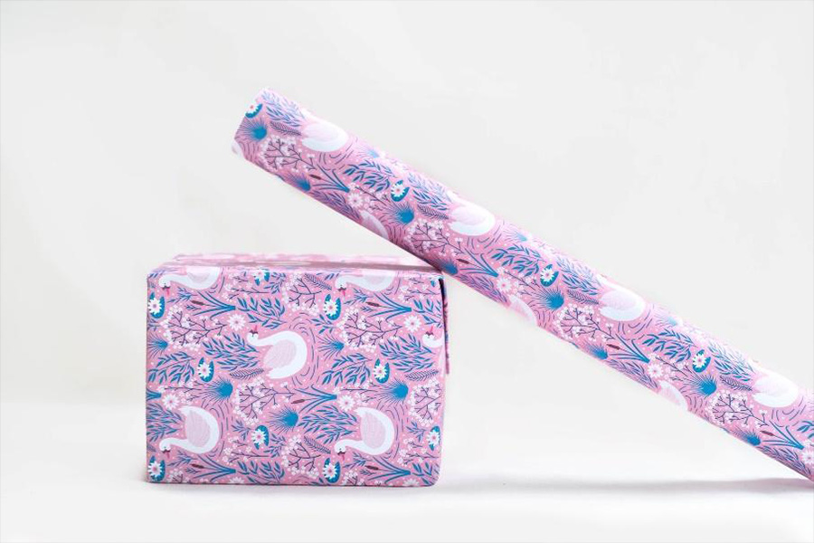 Pink, blue and white gift wrap leaning on wrapped box