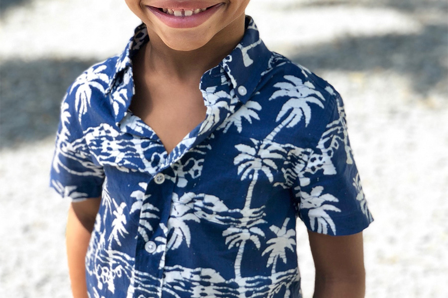 Smiling child rocking a printed shirt