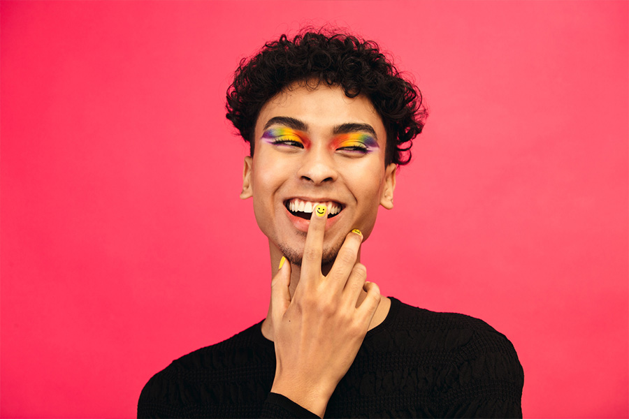 Smiling man with colorful nail art