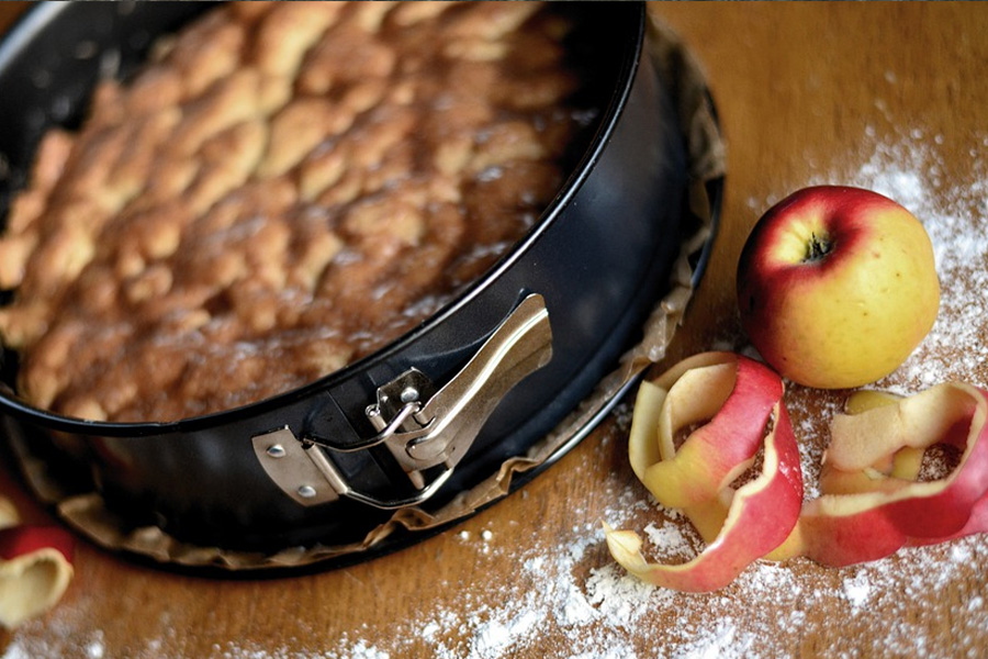 Springform pan placed near an apple
