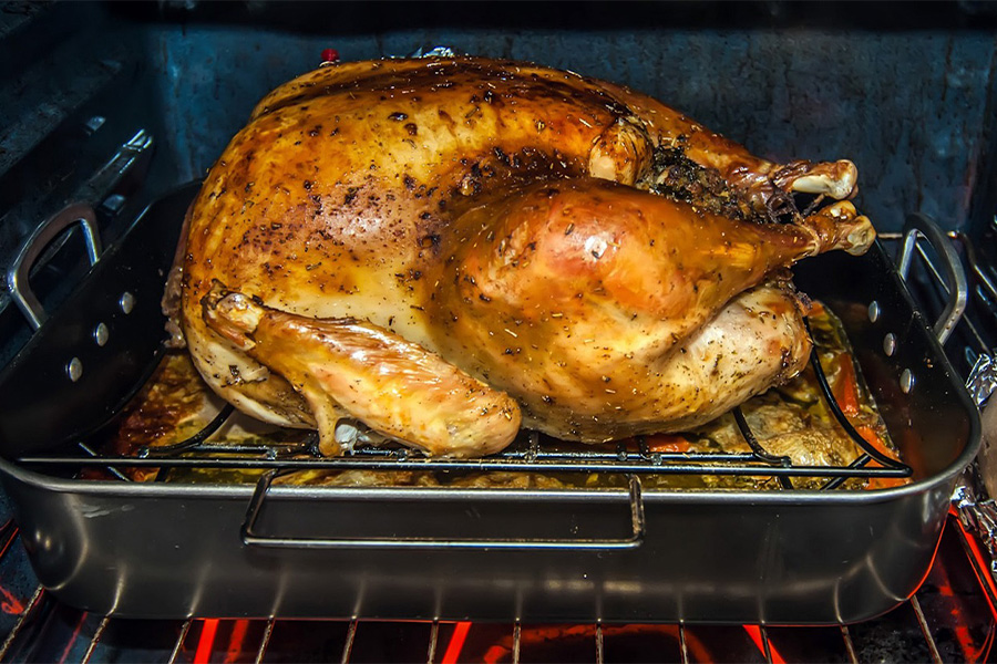 Turkey cooking in a big roasting pan