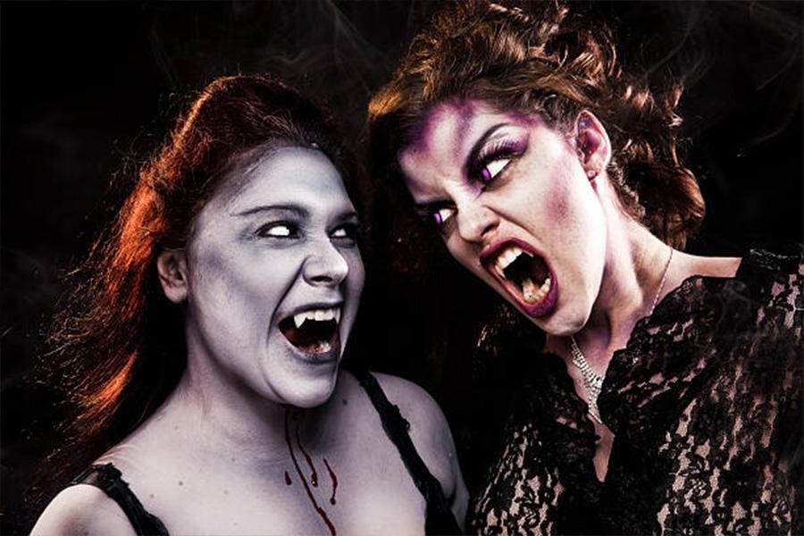 Two women dressed as vampires with SFX makeup on