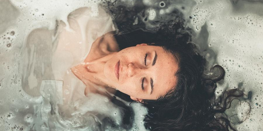 Woman closing eyes during a bath session