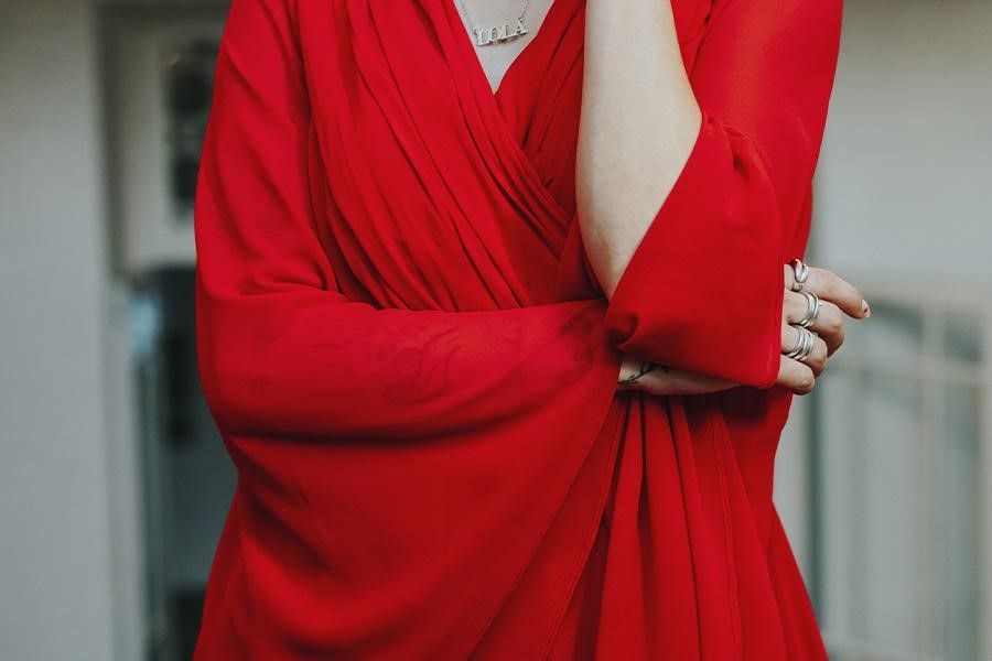Woman posing with red bleisure dress