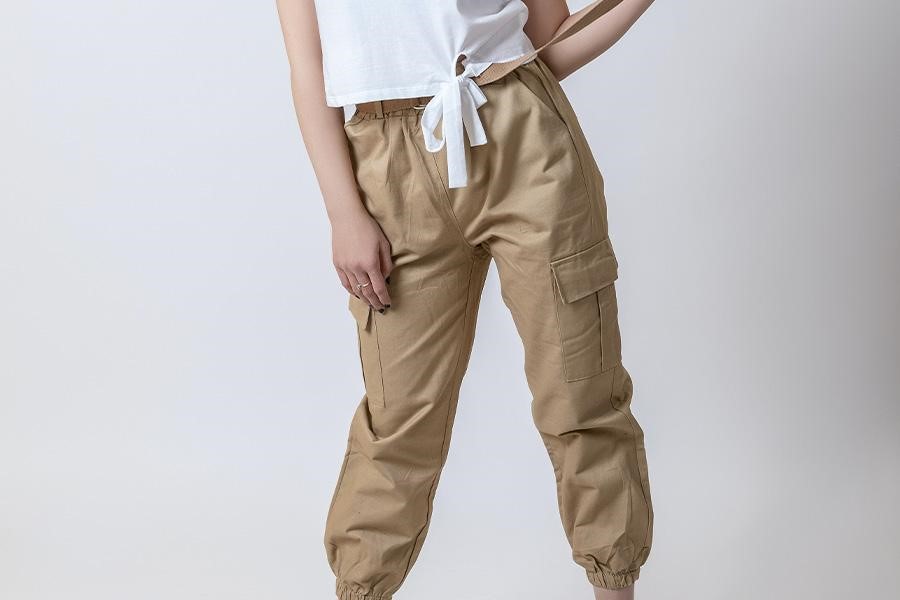 Woman rocking rich brown military trousers with white knot-top