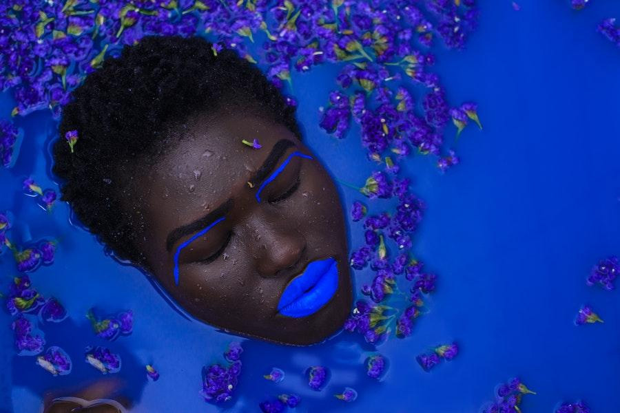 Woman slow-bathing in blue bath waters