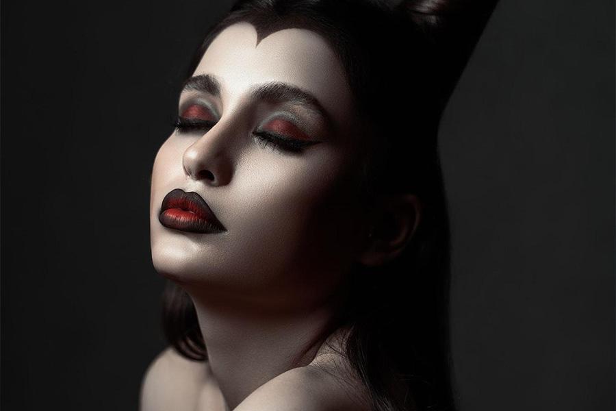 Woman wearing dark avatar makeup