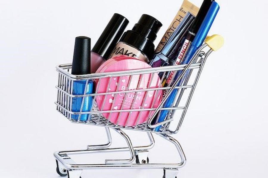 A collection of cosmetics in a mini cart