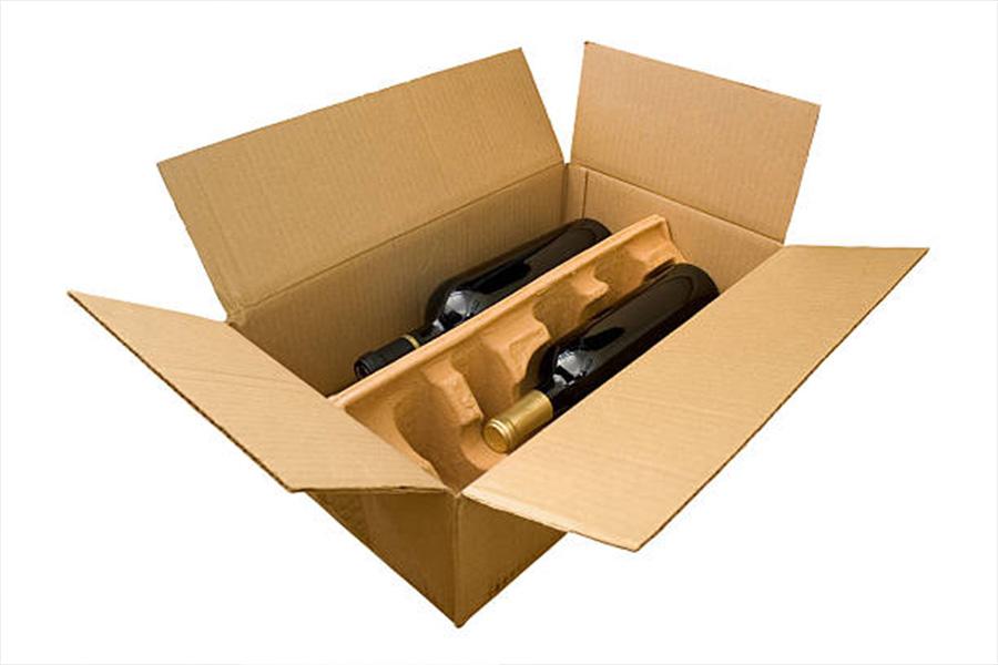 A large cardboard box with wine bottles in padding