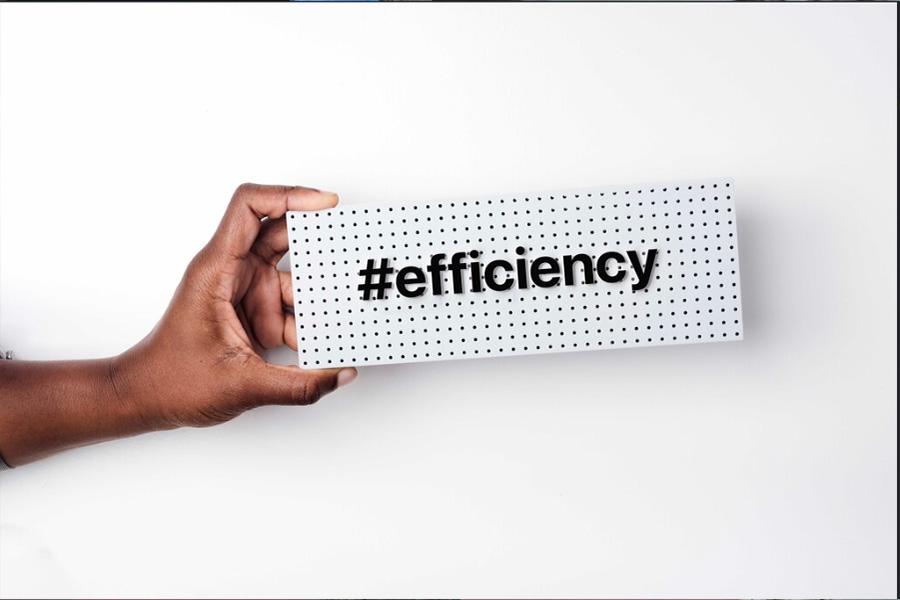 A person holding an efficiency signboard