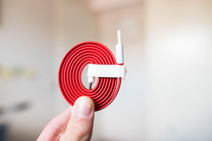 A red color USB cable coiled up