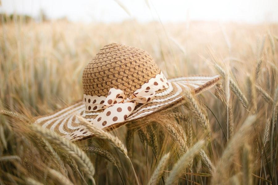 Beautiful straw hat resting on a field