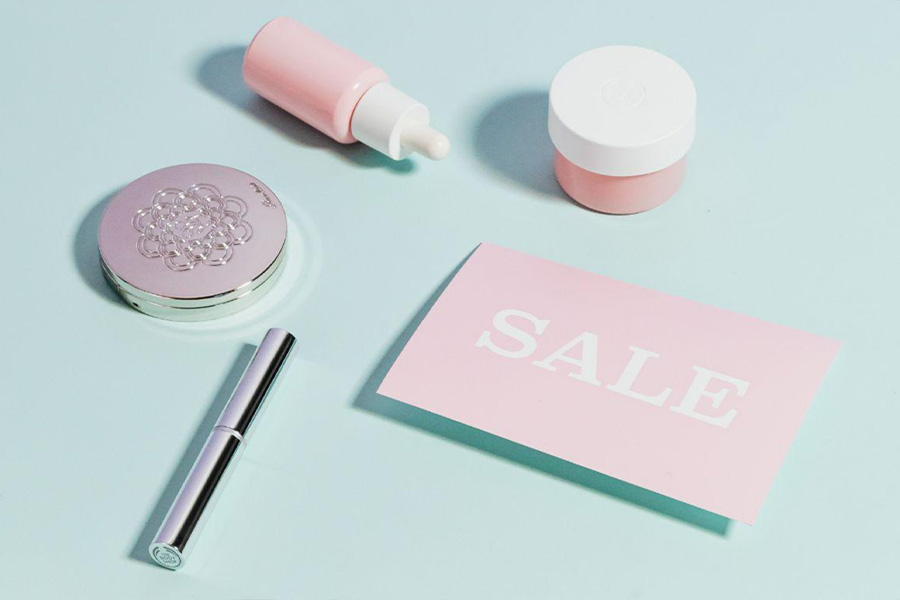 Beauty products placed next to a sale sign