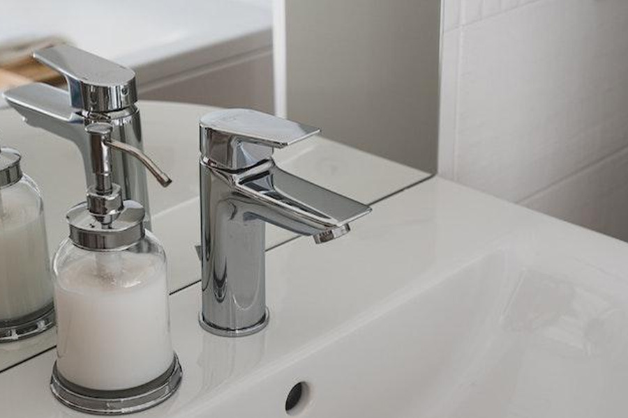 Close-up Photo of White Ceramic Sink With Stainless Steel Faucet