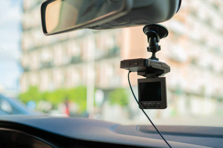 Dash camera with a screen hanging inside car windshield
