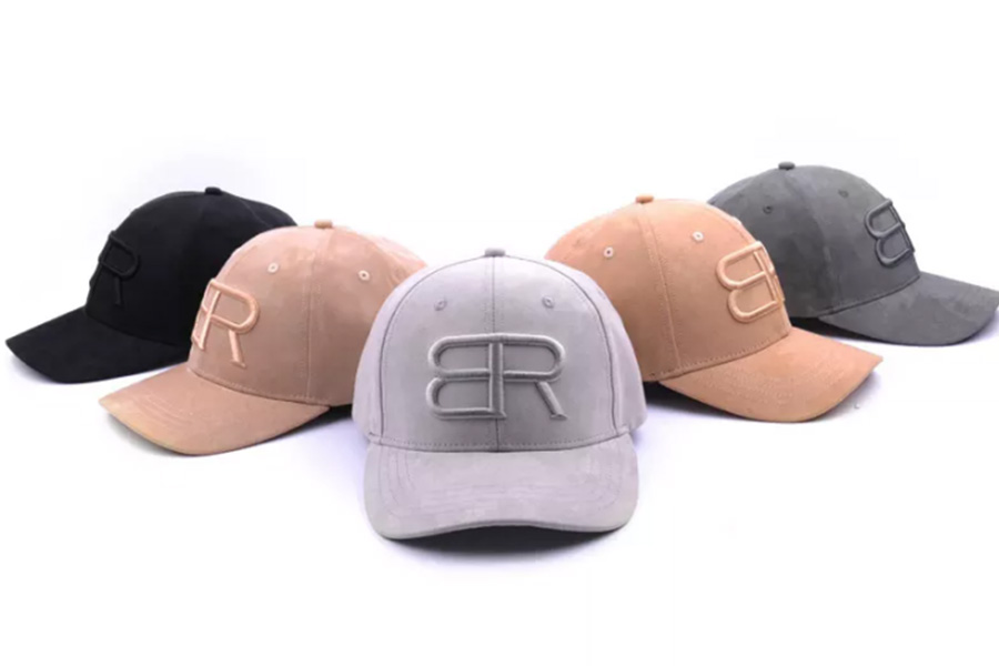 Five different colors of suede caps with logo on front