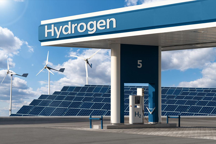 Hydrogen filling station next to solar panels and wind turbines