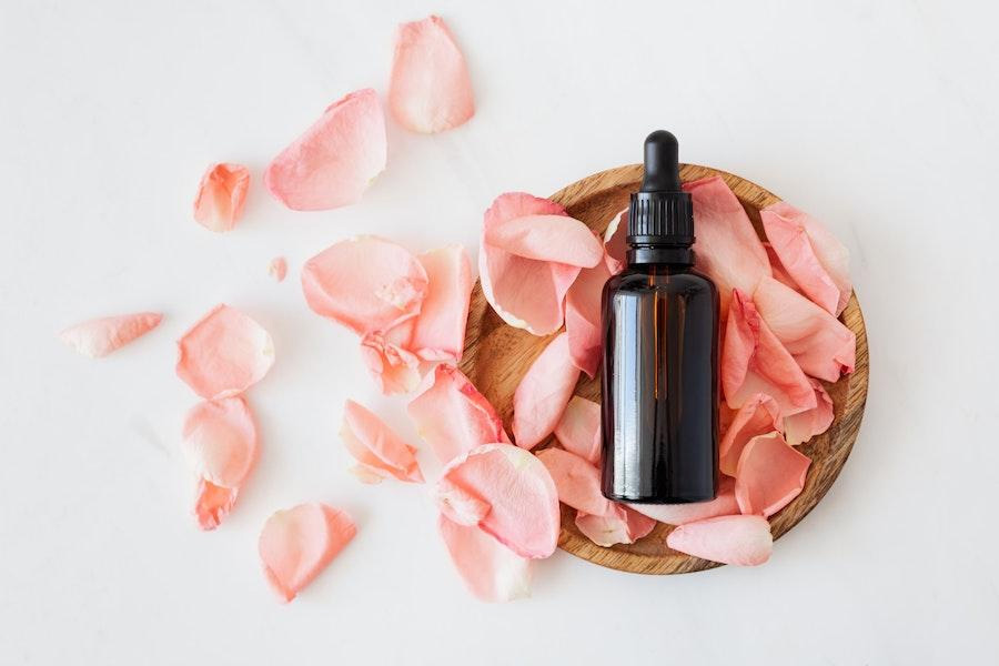 intimate care bottle with pink rose petals