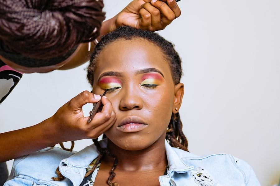 Makeup artist styling a woman’s face
