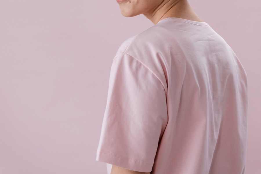 man posing in a pink weathered jersey tee