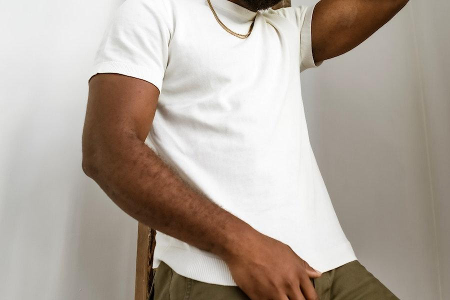 man posing in a white short-sleeve tee