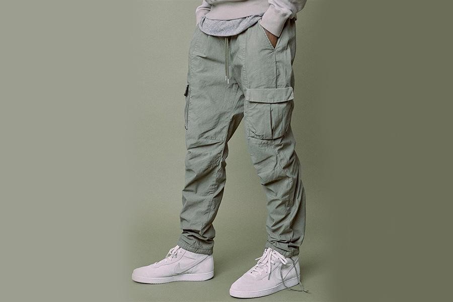 Man posing in gray cargo pants