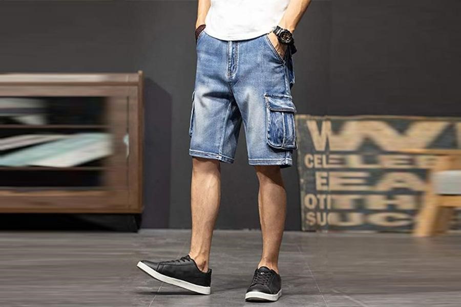 Man posing with washed denim cargo shorts
