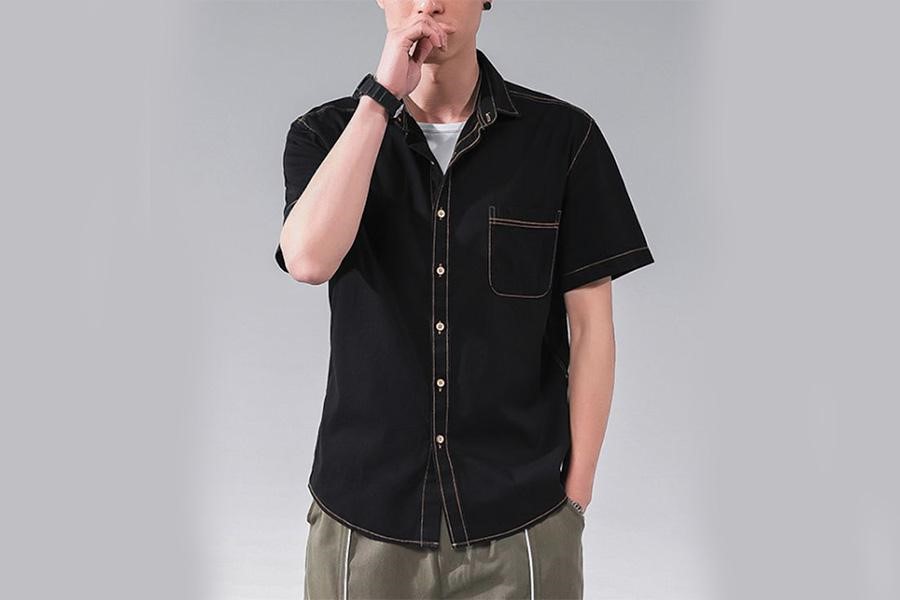 Man wearing a black denim resort shirt
