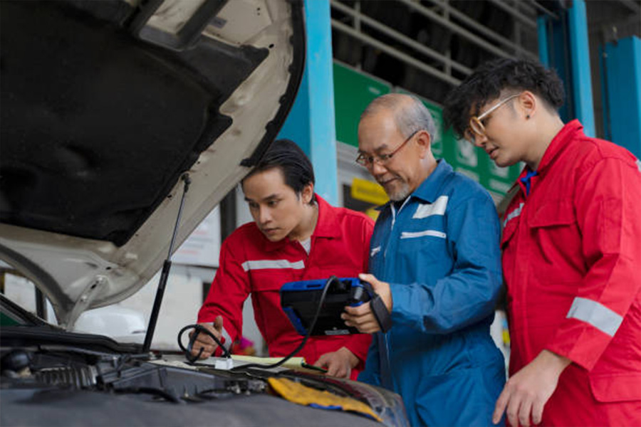 Men using OBD-2 on a vehicle
