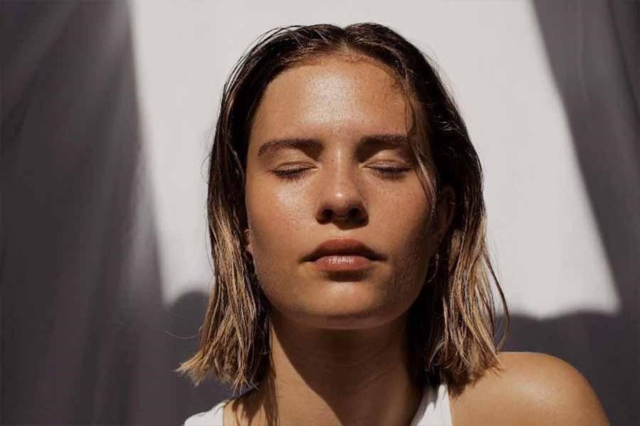 Model with wet hair and glowing skin