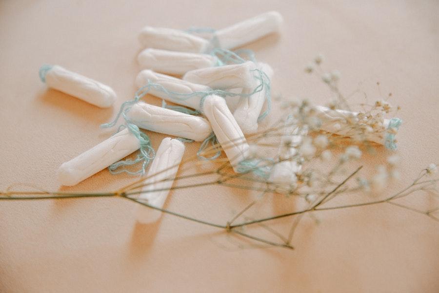 Multiple genderless white tampons with blue strings