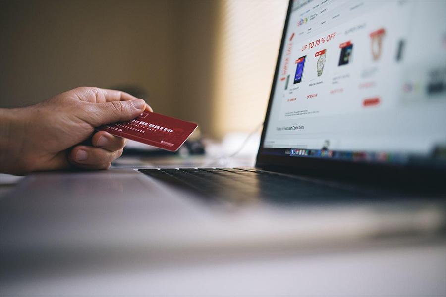 Person holding a credit card and shopping online