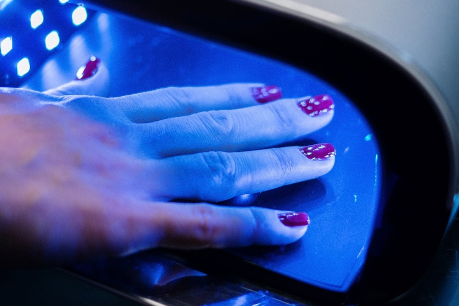 Person’s hand in a UV nail dryer