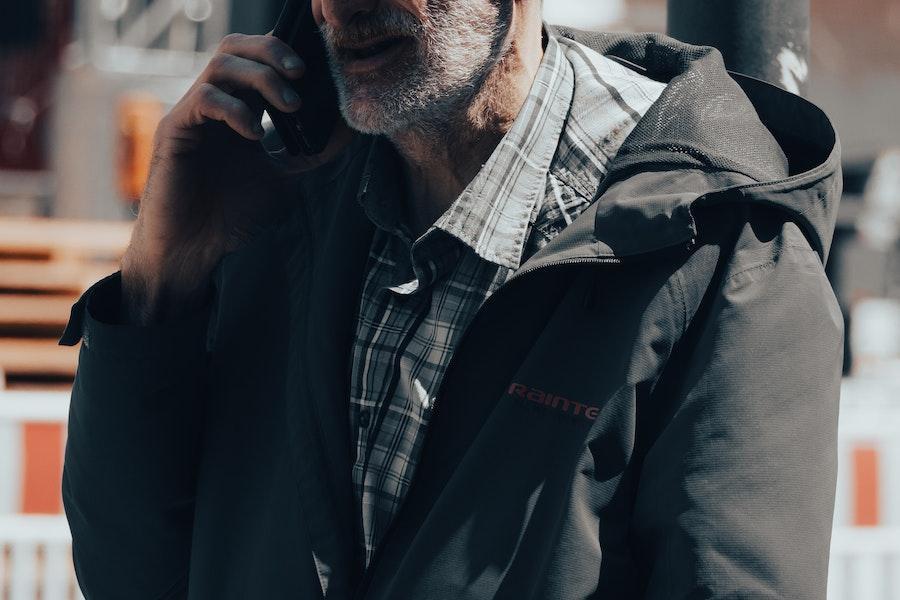 Senior citizen wearing a grey cagoule