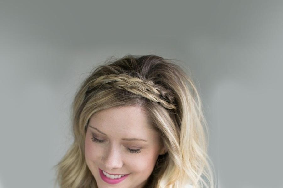Smiling woman wearing a blonde faux braid hairband