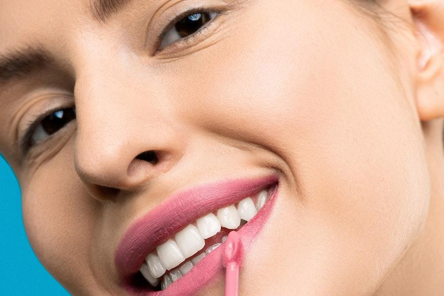 Smiling woman wearing a pink lipstick shade