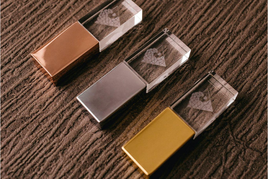Three USB flash drives in different colors