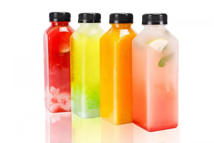 Various types of juice inside plastic fruit juice bottles