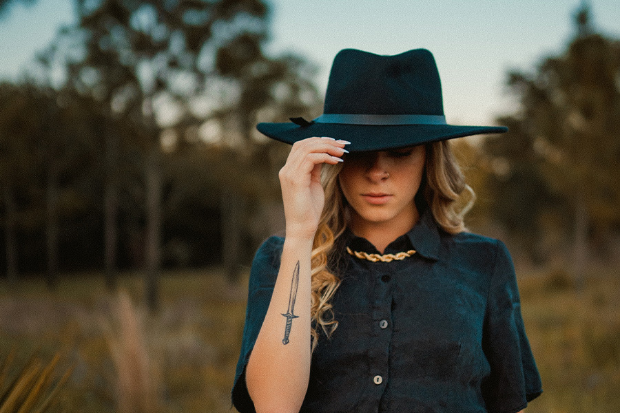 Woman posing in a black Bangora cowboy straw hat