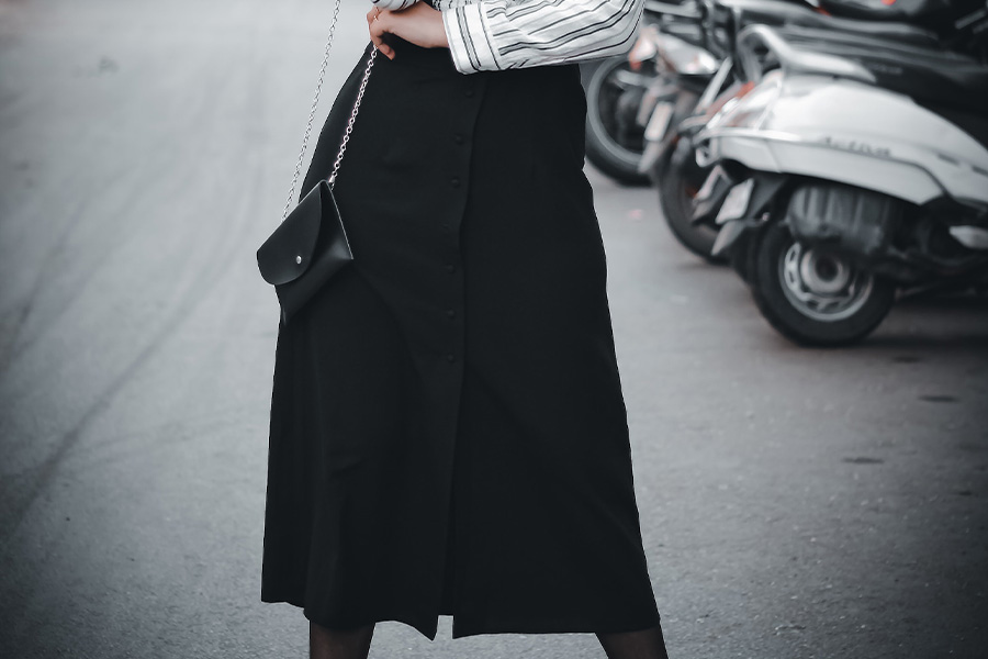 woman posing on road with a black adjustable skirt