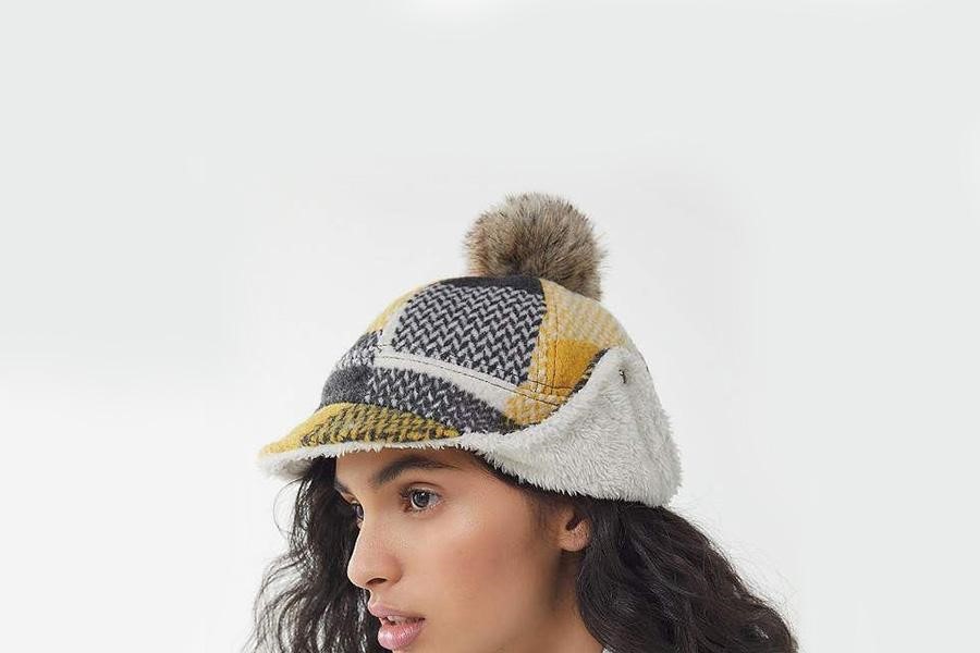 Woman posing with a deerstalker hat
