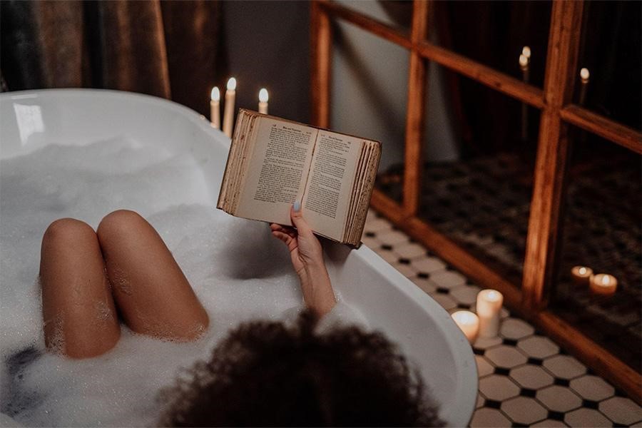 Woman relaxing in a bathtub