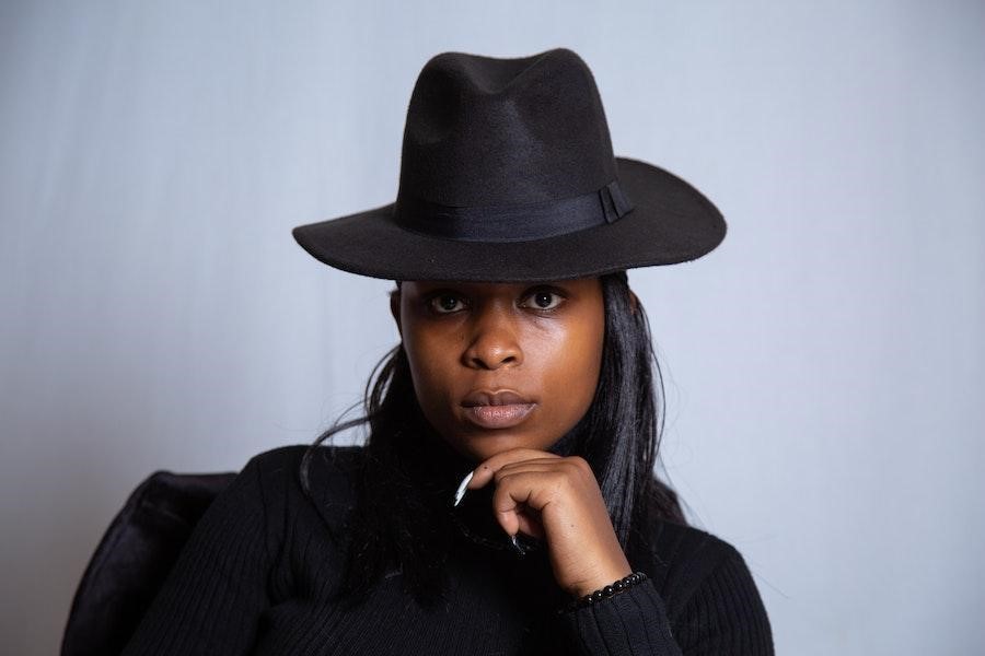 Woman rocking a pose with a black fedora