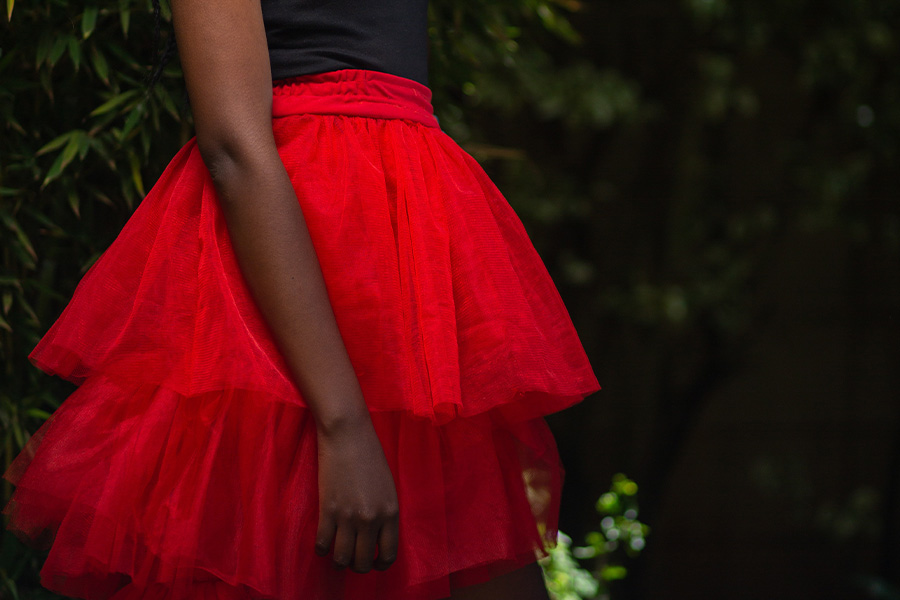 woman rocking a red skirt with extra layers